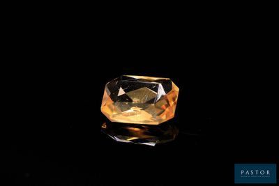 a yellow diamond on a black surface