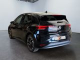the rear of a black car is parked in a showroom