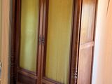 a large wooden armoire in the corner of a room