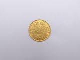 a close up of a gold coin on a white surface