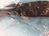 a fish that is wrapped in plastic and sitting on a table