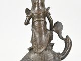 an image of a statue of an elephant with a hat on it ' s head
