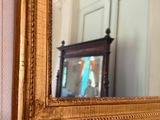 a mirror hanging on the wall next to a door