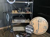 a photo of a room with a clock, a camera, and other items