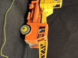 a toy truck with a crane attached to it ' s back