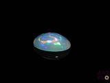 an image of a white oplite in the dark