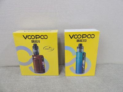 Deux boîtes de cigarettes électroniques sont posées sur un canapé.