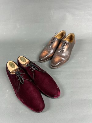 two pairs of men ' s shoes are lined up on a table