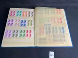 a close up of a book with stamps on it on a table