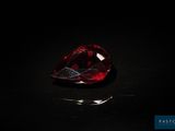 a red diamond on a black surface in the dark