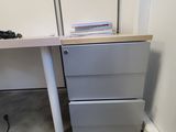 a desk with two drawers and a chair next to it