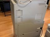 a printer sitting on top of a machine in a room