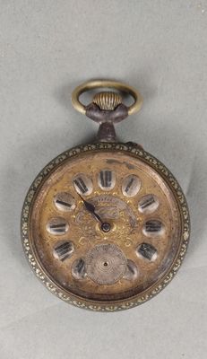 an old pocket watch that is sitting on a table