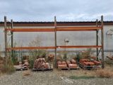 many stacks of bricks sitting on pallets in front of a building