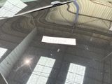 a sign on the windshield of a car that is parked in a garage