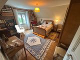 an image of a bedroom with a bed and a desk in it