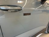 a close up of a car door handle with a sticker on it