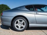 a silver sports car parked on the side of the road