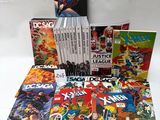 a bunch of comics sitting on top of each other on a table
