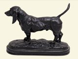 statue of a black dog standing on a black base on a white background