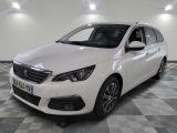 the white car is parked on a checkered floor in the garage