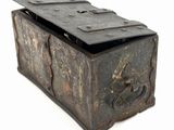 an old wooden box with a metal latch on top of it
