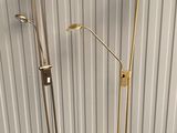 pair of brass floor lamps in the style of person