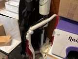 a pile of boxes and a vacuum in the corner of a room