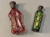 two glass bottles that are sitting next to each other