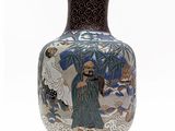 a vase with a painting on it on a white surface