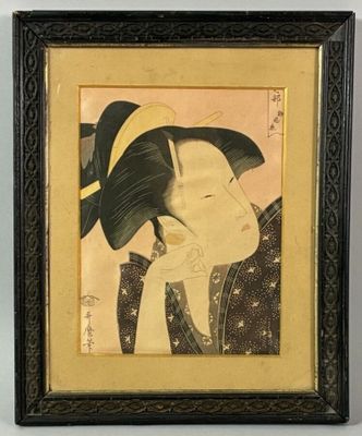 a framed picture of a woman with a hat on her head
