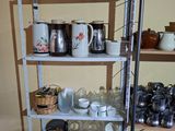 a shelf with cups, mugs, and other items on it