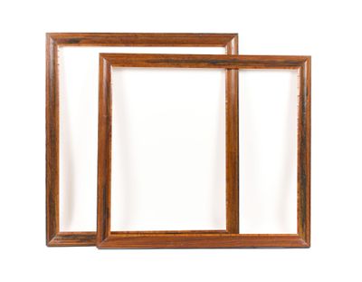 two wooden picture frames on a white wall with a white background