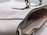 a white purse with a zipper on the inside of it