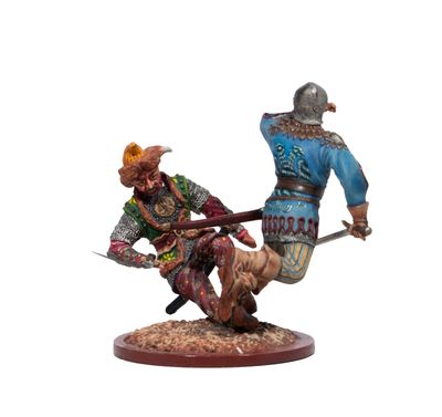 figurine of a man and a woman fighting with swords