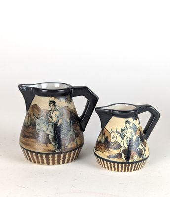 two small vases sitting next to each other on a table