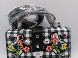 a black and white checkered purse with flowers on it