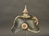 a helmet with a dragon on it on a stand