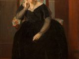 portrait of a woman in a black dress sitting in a chair