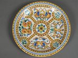 a close up of a decorative plate with flowers and birds on it