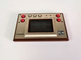 an old nintendo game console sitting on top of a white table