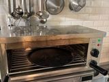 an oven with a pan on top of it in a kitchen