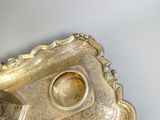a silver plate with a decorative design on it