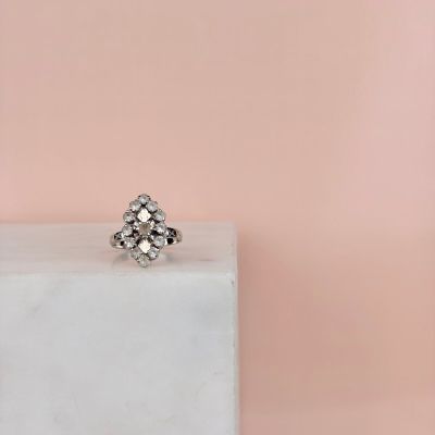 an image of a diamond ring sitting on top of a marble block