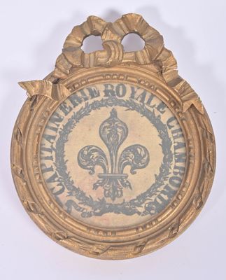 an image of a gold plaque with a fleur de lis on it