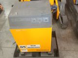 a yellow forklift with a black and gray box on it