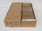 an open cardboard box filled with lots of papers sitting on top of a table
