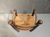 a wooden chair that has a wooden seat on top of it