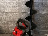 a picture of a man ' s tool on the ground next to a pole