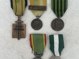 three medals and a medal are sitting on a white surface